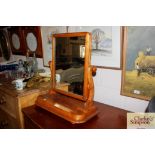 A mahogany swing framed toilet mirror