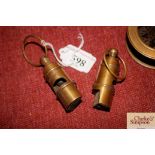 Two brass Titan style whistles