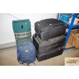 A quantity of miscellaneous suitcases; wool etc