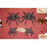 Two large and two small cast iron spider ornaments