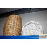 A wicker magazine rack and a wicker laundry basket