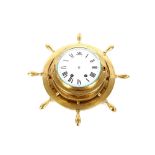 A late 19th / early 20th Century brass bulkhead ships clock, in the form of a ships wheel with