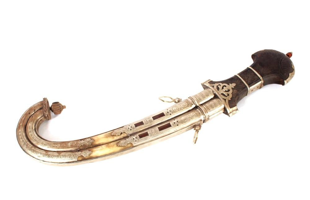 A Khanja Jambyo, Indian sword in white metal, wood and horn mounted scabbard