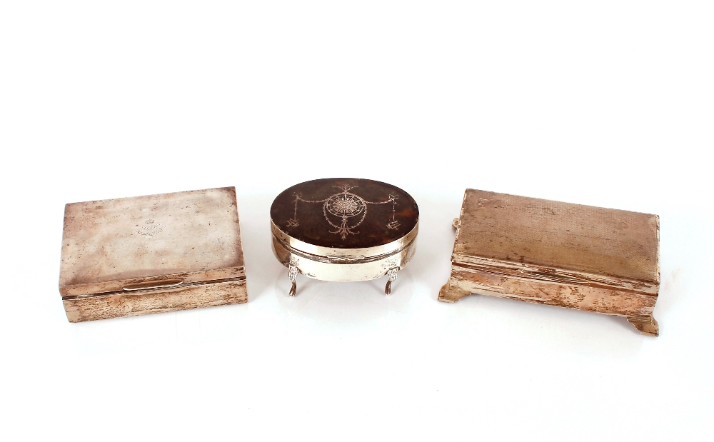 An oval silver and tortoiseshell jewellery box, and two silver cigarette boxes (3)