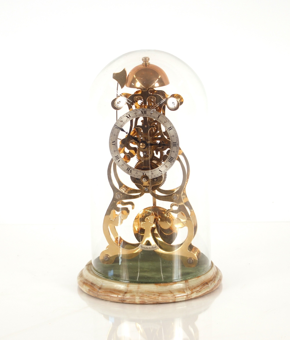 A brass skeleton clock, by Thwaites & Reed Ltd, under glass dome and set on onyx base, striking on a - Image 2 of 2