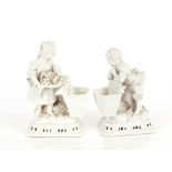 A pair of Meissen blanc de chine posy vases, in the form of children with baskets, having floral