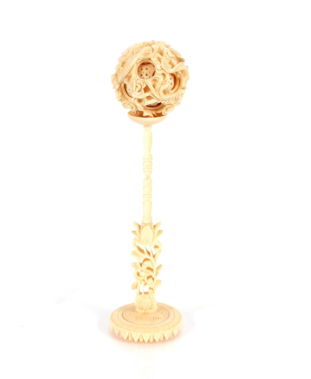 A 19th Century carved ivory puzzle ball on stand