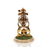 A brass skeleton clock, by Thwaites & Reed Ltd, under glass dome and set on onyx base, striking on a