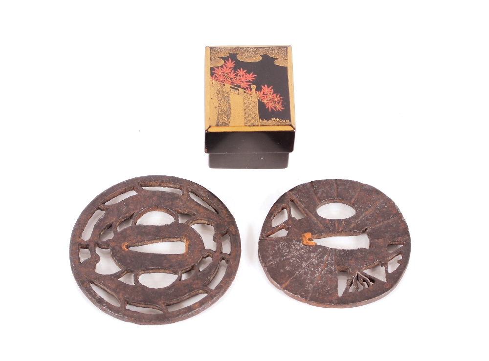 Two antique Japanese pierced iron Tsuba; and a finely painted small lacquered box and cover with