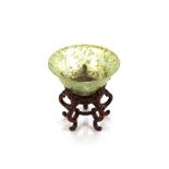 A green jade bowl, 10cm dia. on carved hardwood stand