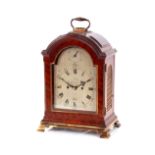 A 19th Century mahogany and brass mounted bracket clock, the domed case surmounted by a carrying
