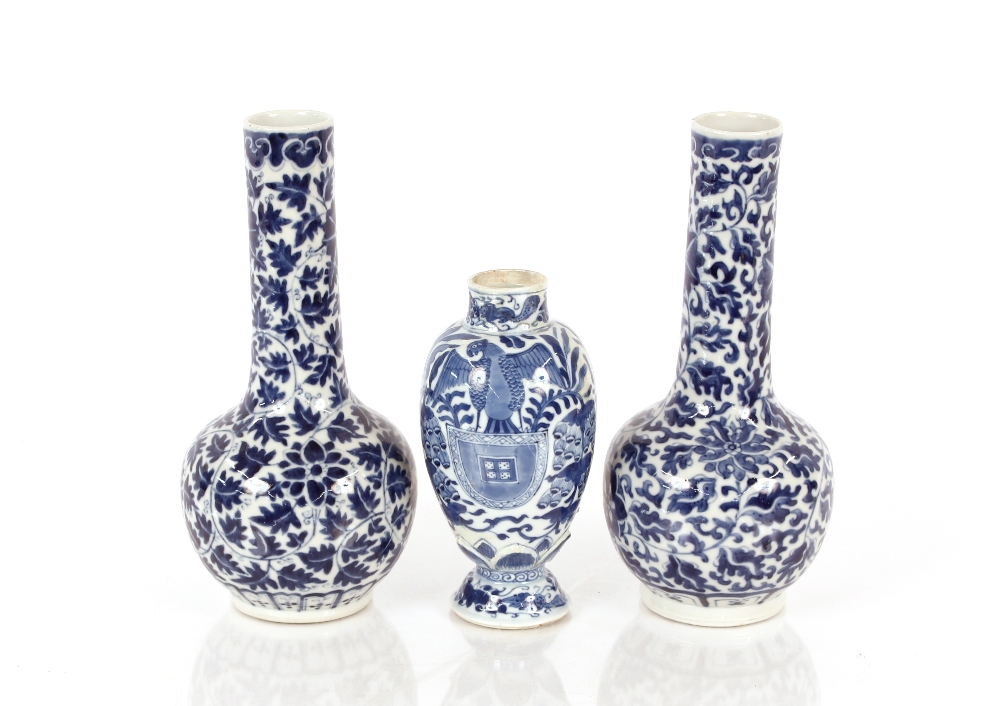 A pair of 19th Century Chinese bottle vases, having all over floral decoration, 27cm high; and a