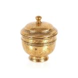 A finely engraved 19th Century Sino Tibetan brass bowl and cover, 15cm high; and a small gilt