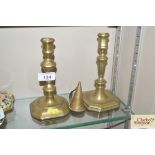 A pair of antique brass candlesticks and brass snu
