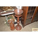 A plant stand and a wooden bowl