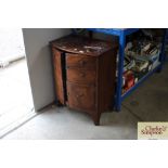 A mahogany bow front cupboard