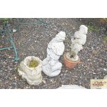 Three concrete garden ornaments