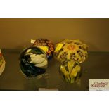 Four various coloured glass paperweights; various