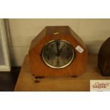 An Art Deco walnut cased chiming mantel clock