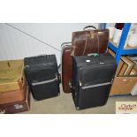 Three suitcases and a leather bag