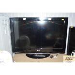 An LG flat screen television with remote control