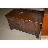 An oak coffer with linen fold panelled front