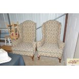 A pair of wing back armchairs