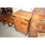 A stripped pine nest of drawers