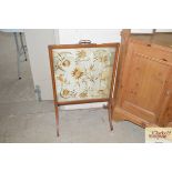 An Edwardian satin wood firescreen with embroidere