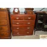 An Edwardian walnut chest of two short and three l