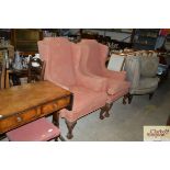 A pair of George III style wingback armchairs rais