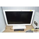 A Toshiba flat screen TV with remote control
