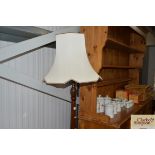 A mahogany standard lamp and shade