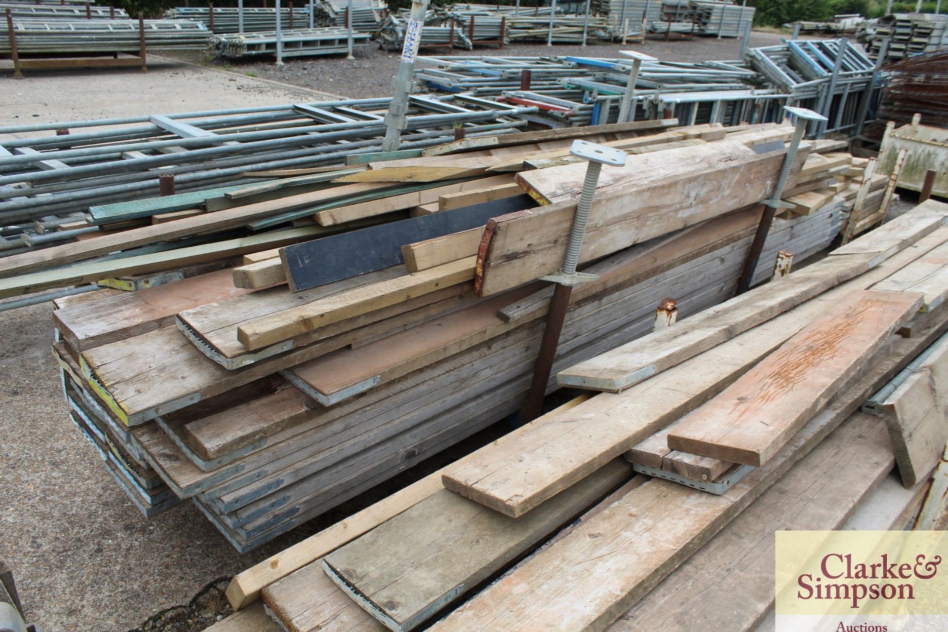 Stillage of scaffold boards and other timber.