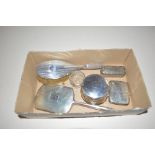 A silver backed dressing table hand mirror and bru