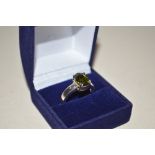 A green topaz and silver dress ring