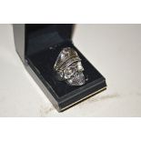 A silvered skull ring