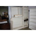 Four white painted open fronted bookcases