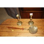 A pair of antique brass candle sticks and a brass