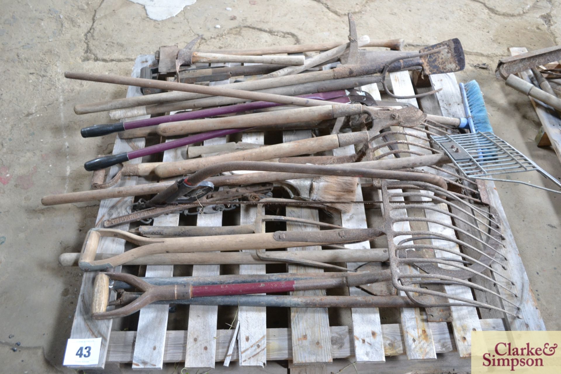 Pallet containing large quantity of long handled tools.