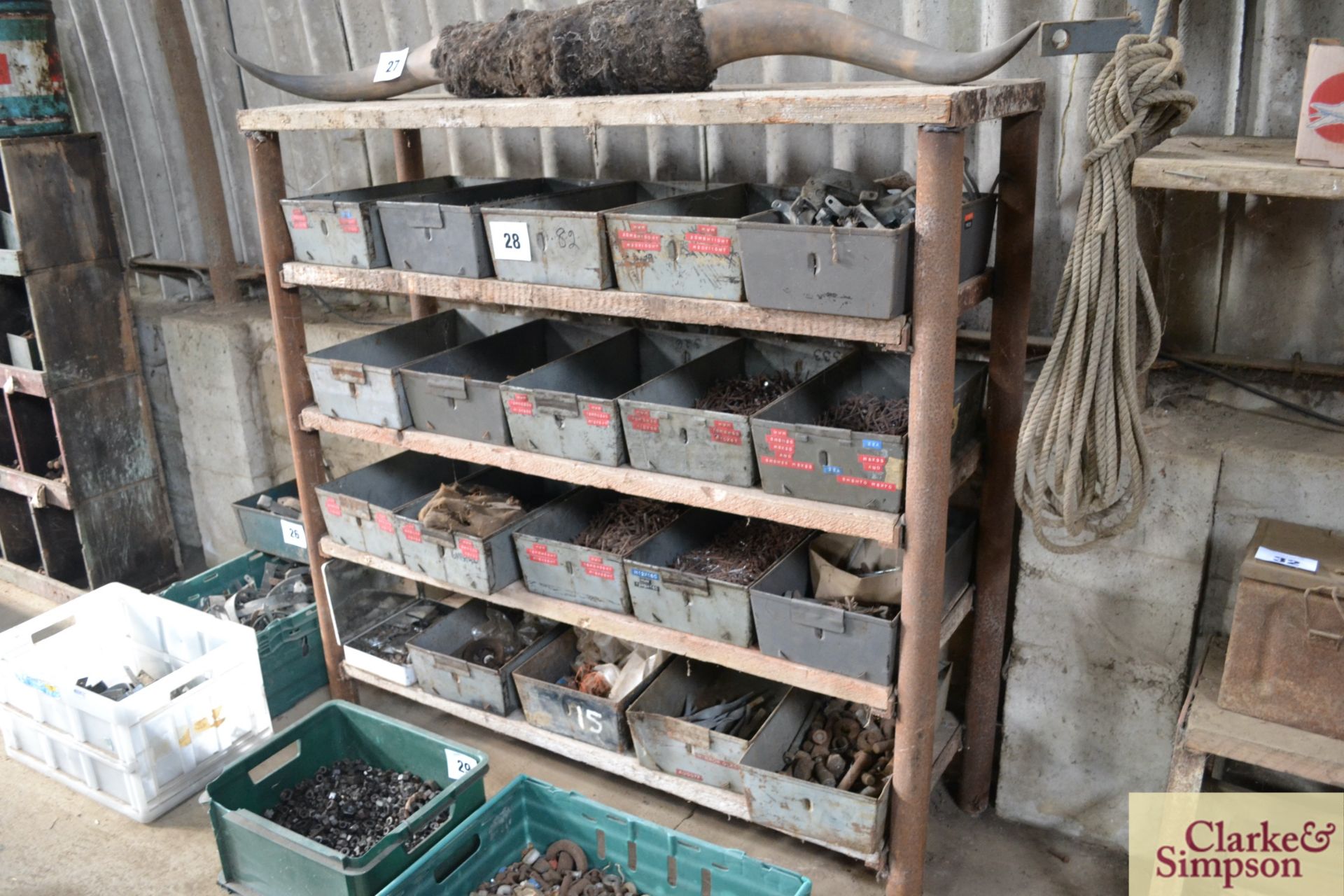 Parts storage rack with large quantity of bins and contents of nails and fasteners.