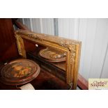 A large ornate gilt framed mirror