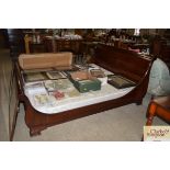 A mahogany sleigh bed