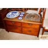 A low mahogany chest fitted with two short and two