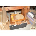 A box of various wooden ware to include a bread pl