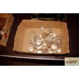 A box containing various decanters stoppers etc.