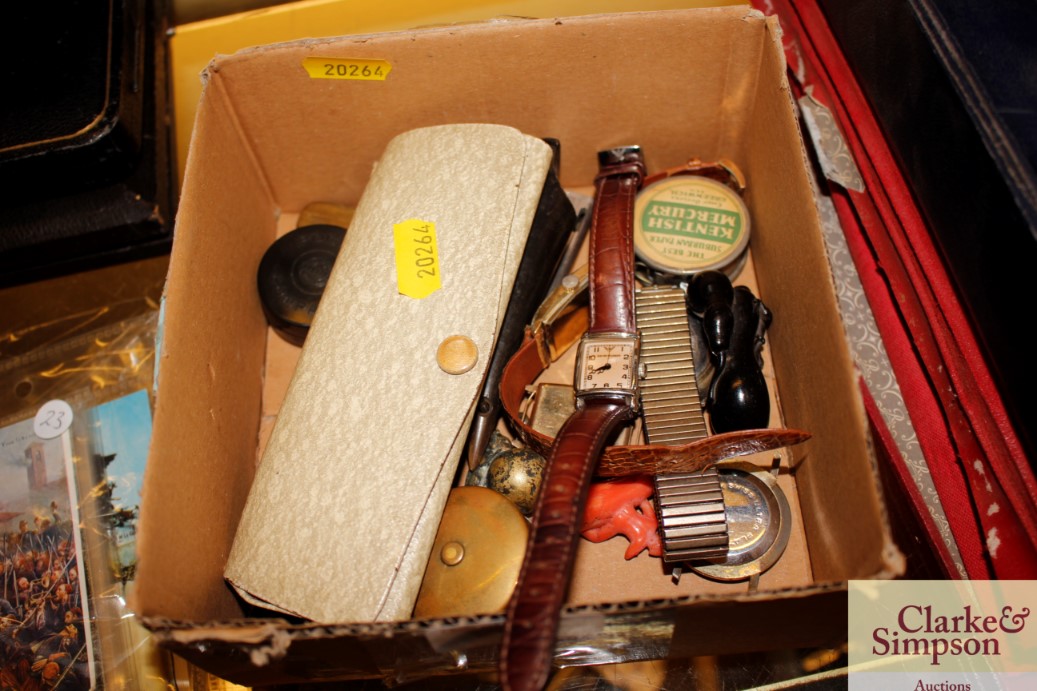 A box containing wrist watches, sunglasses, horn w