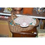 A wicker dolls basket; a shell shaped cushion