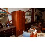 A mahogany gents wardrobe fitted two drawers below