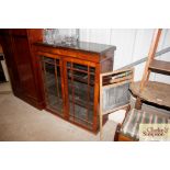 A 19th Century walnut and box strung bookcase, the
